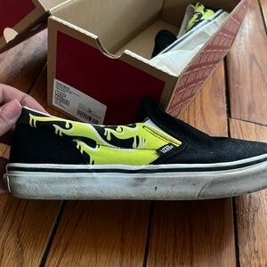 Heavily worn Vans slip on sneakers